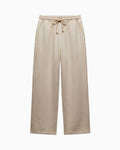 A pair of wide-leg sweatpants in a light beige or oatmeal color, featuring an elastic waistband with a matching drawstring, shown against a plain white background.