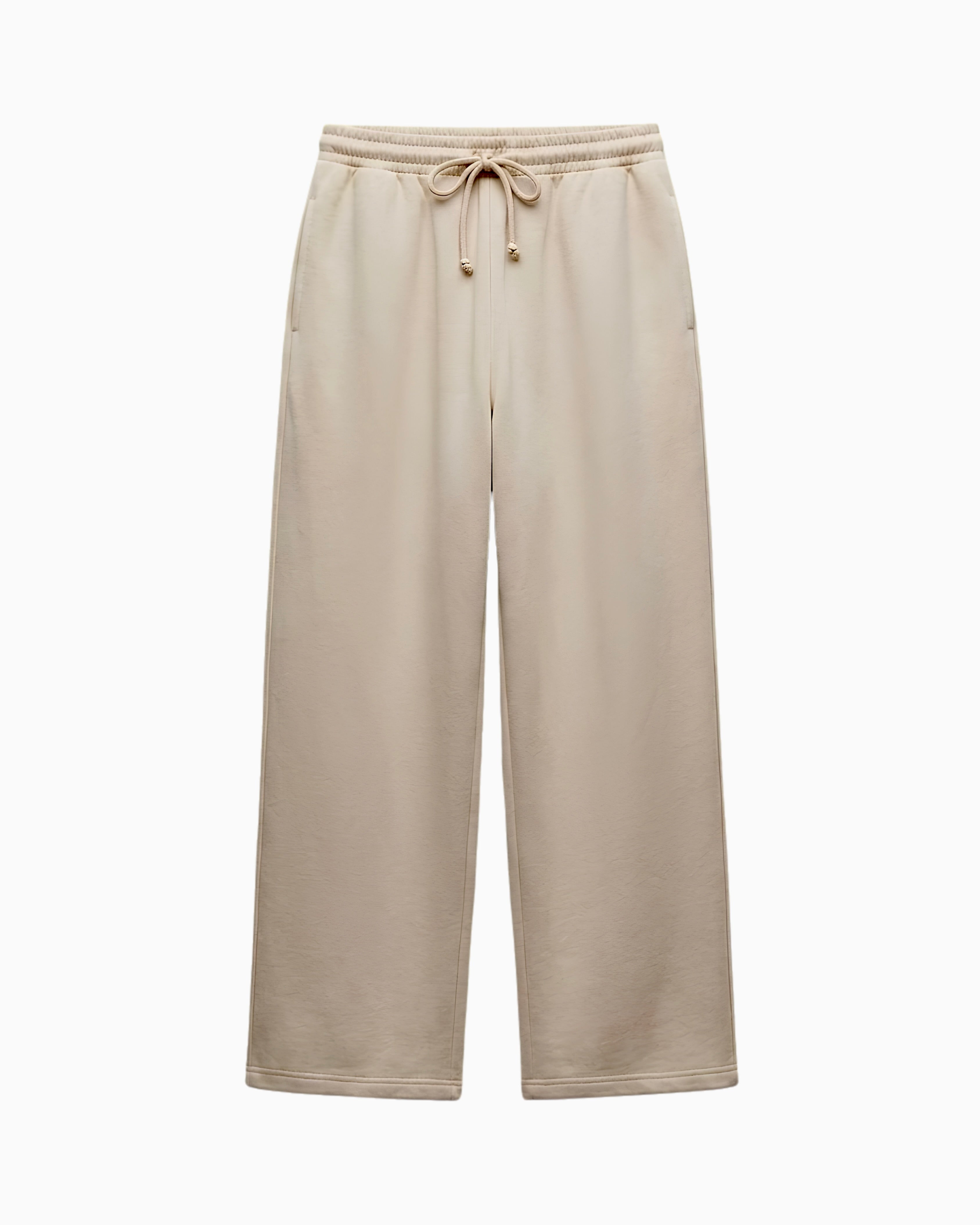 A pair of wide-leg sweatpants in a light beige or oatmeal color, featuring an elastic waistband with a matching drawstring, shown against a plain white background.
