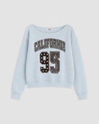A light blue long-sleeve sweatshirt with 'CALIFORNIA 95' printed on the front in distressed varsity-style lettering, shown against a light gray background.